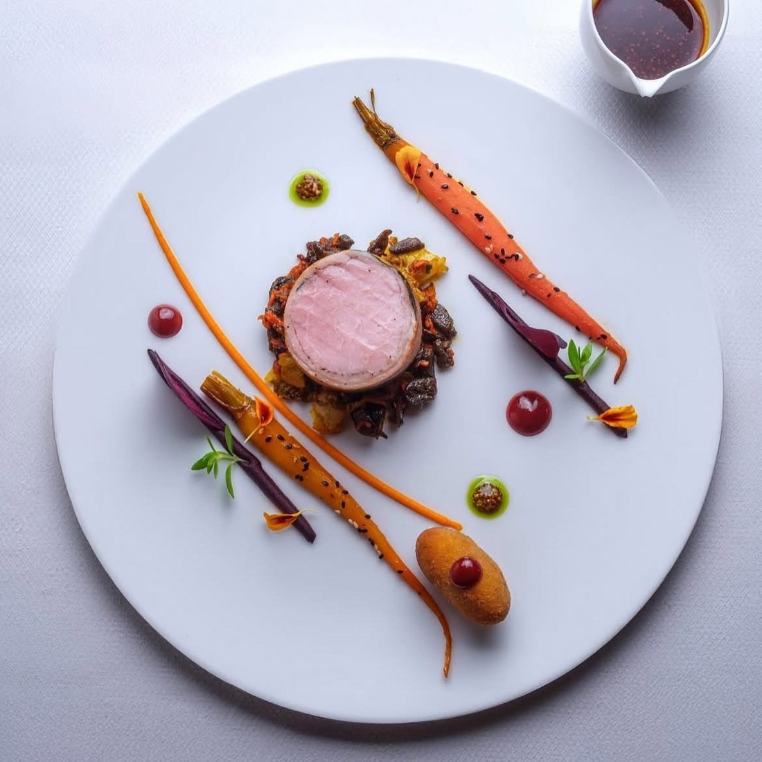 Pork tenderloin with glazed carrots and croquette